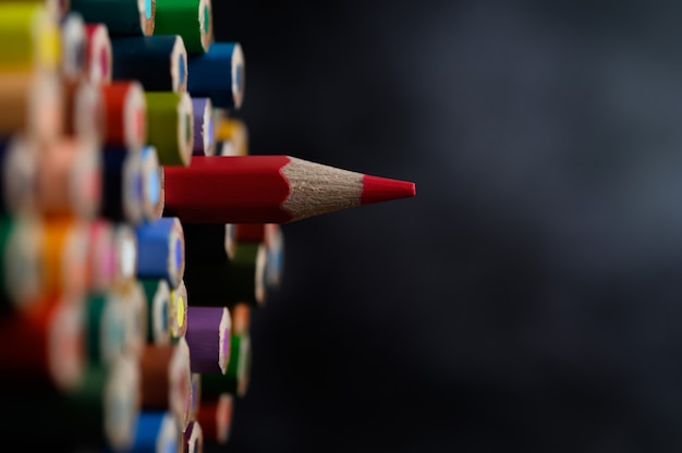 Closeup with a group of colored pencils, selected focus, red