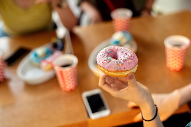 Closeup of woman eating glazed donut