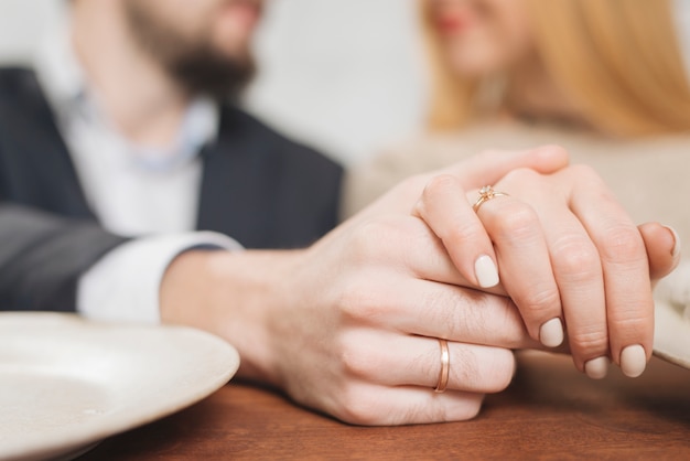 Free Photo closeup of woman and man holding hands