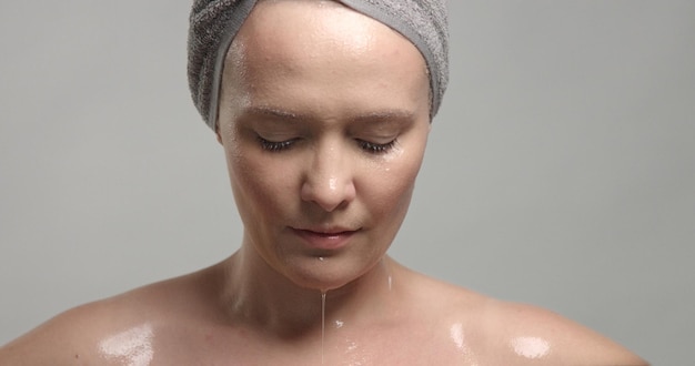 Free photo closeup of woman's face with wet skin with drops of water on it mousturizing skin concept