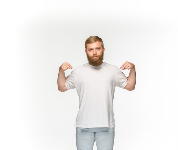 Closeup of young man's body in empty white t-shirt isolated on white background. Mock up for disign concept