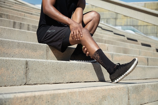 Closeup of young man with knee injury