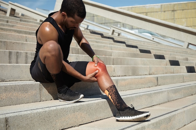 Closeup of young man with knee injury