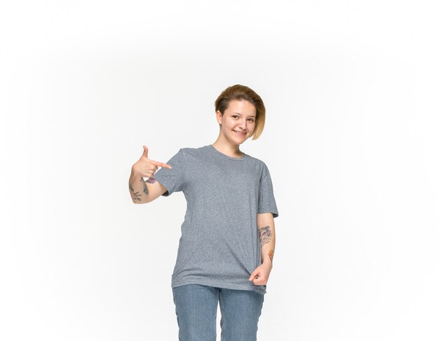 Closeup of young woman's body in empty gray t-shirt isolated on white