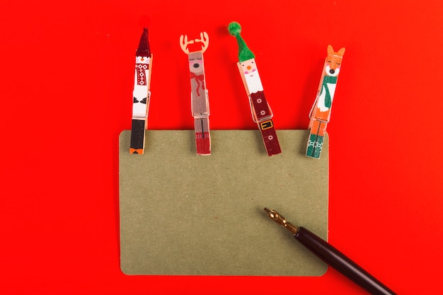 Clothes pegs decorated for Christmas with sign and pen 