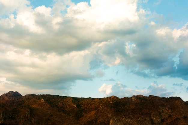 Free photo clouds over a mountain