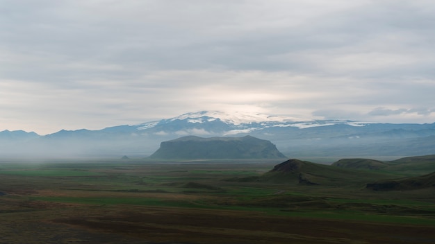 Free photo cloudy nature landscape by lake