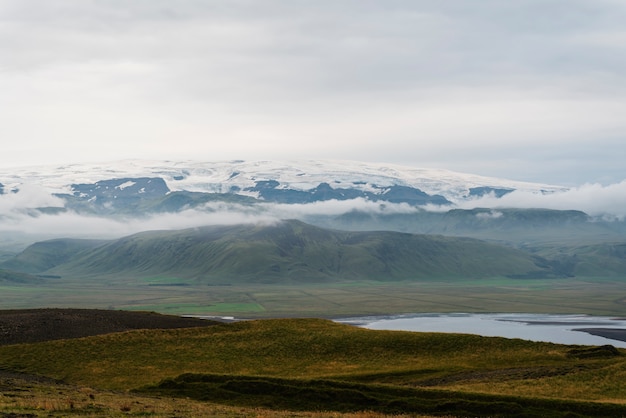 Free Photo cloudy nature landscape by lake