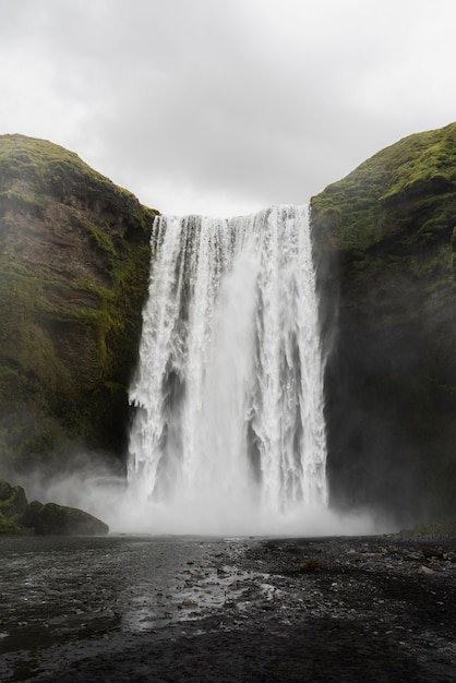 Cloudy nature landscape near waterfall