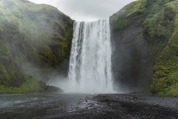 Cloudy nature landscape near waterfall