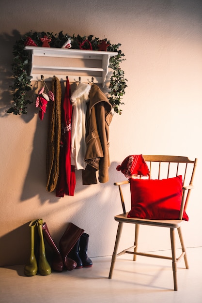 Free photo coat rack with hanging winter clothes