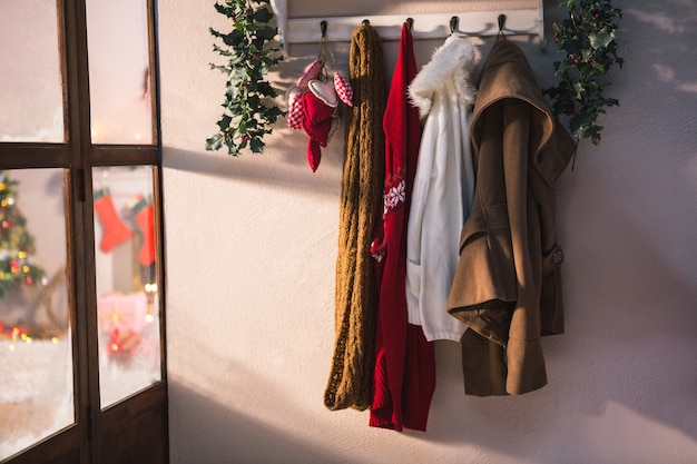 Free photo coat rack with hanging winter clothes