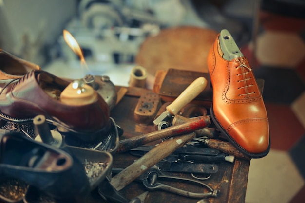 Free photo cobbler works in his workshop