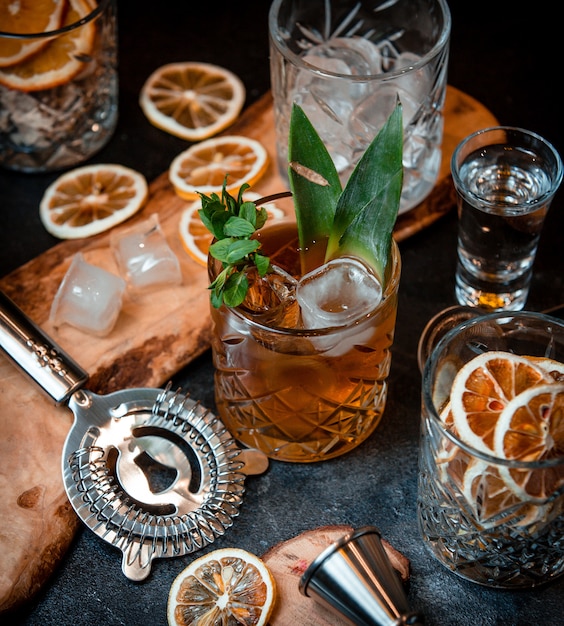 Cocktail with ice cubes and mint leaves