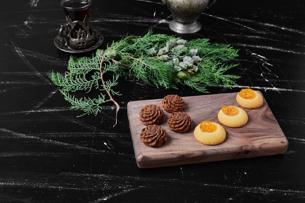 Cocoa and butter cookies on a wooden board.