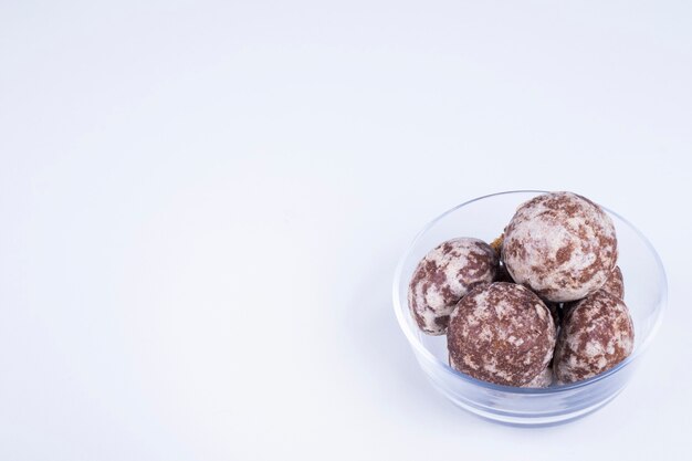 Cocoa gingerbreads in a glass cup on white,  angle view