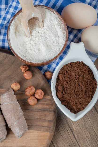 Cocoa wrap mutaki cookies on a wooden board with cinnamon and nuts.