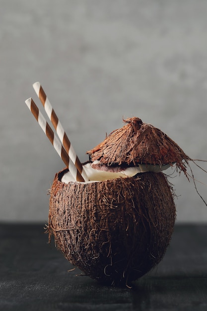 Coconut cocktail with straw. Tropical drink