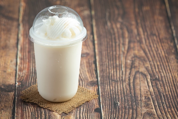 Coconut milk smoothie on a wooden table