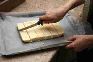 Free photo coconut squares on an oven tray which will eventually be covered with chocolate.