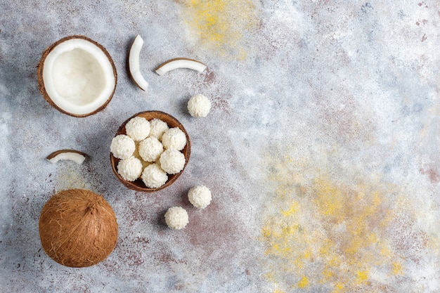 Free photo coconut and white chocolate truffles with half coconut