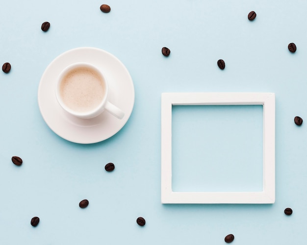 Coffe cup and beans on table