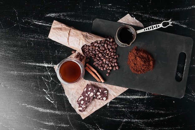 Free Photo coffee beans on black background with powder.