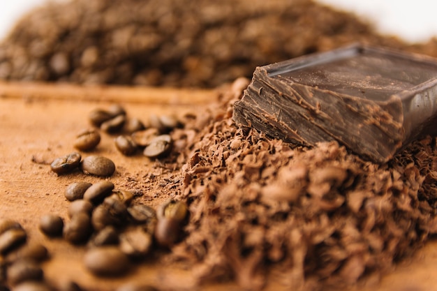 Coffee beans and chocolate chips on chopping board