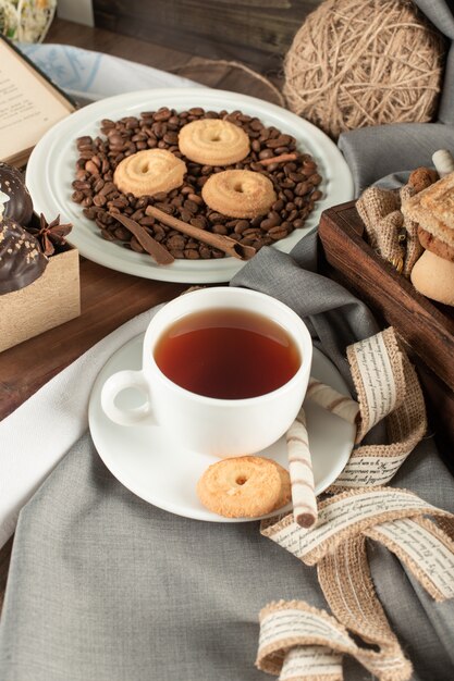 Coffee beans, cookies and a cup of tea.