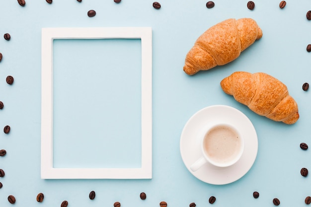 Coffee beans frame with croissants