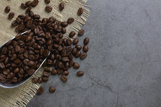 Coffee beans in scoop on table