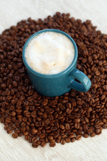 Coffee beans with mug in the middle