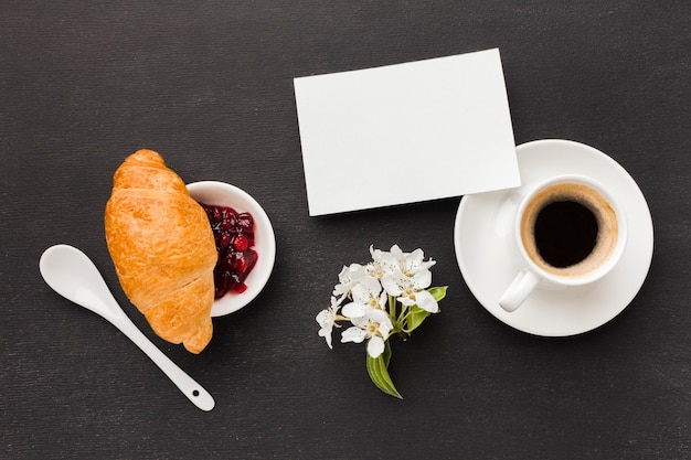 Coffee for breakfast and croissant on table