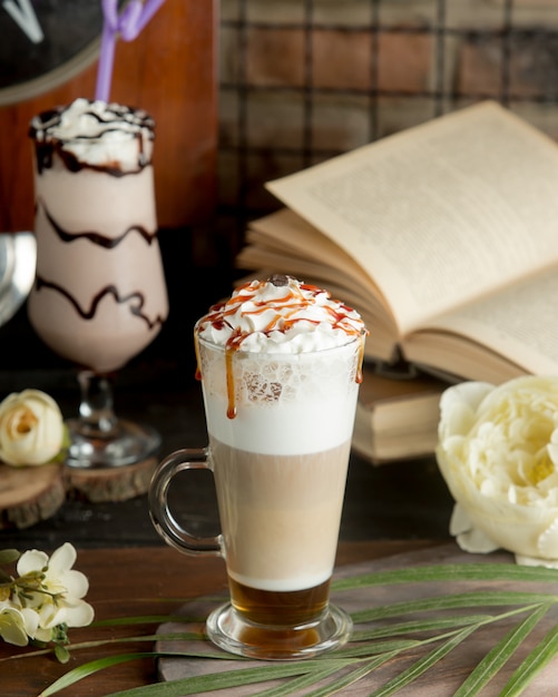 Coffee cocktail with milk and whipping cream in a glass.