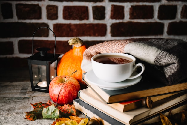 Coffee composed with books and autumnal decor