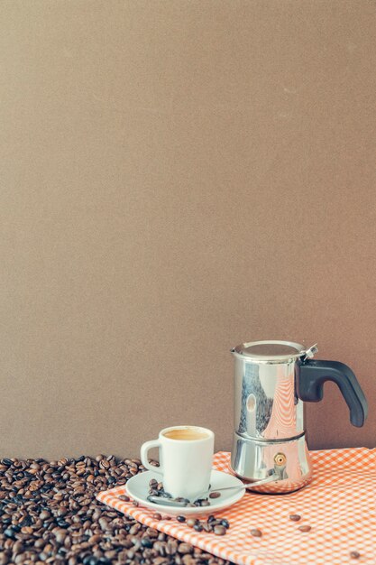 Coffee composition with cup and moka pot on cloth