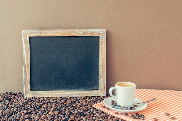 Free photo coffee concept with slate next to espresso on cloth