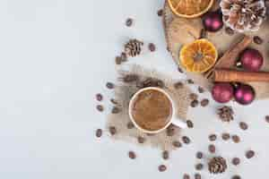 Free photo coffee cup and coffee beans on sackcloth . high quality photo