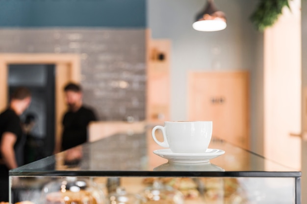 Free Photo coffee cup on glass counter in caf� shop