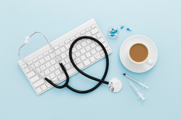 Free photo coffee cup and stethoscope