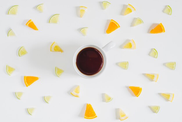 Coffee cup surrounded by fruit bits