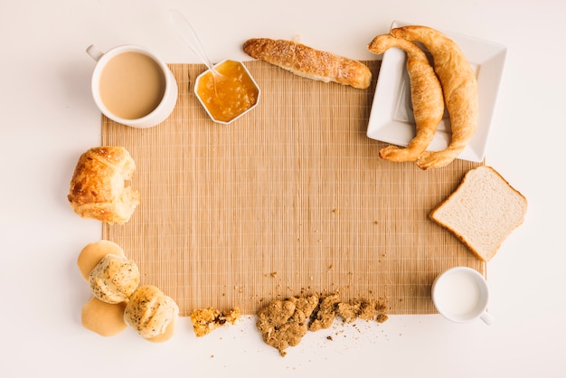 Free Photo coffee cup with different bakery and jam on table