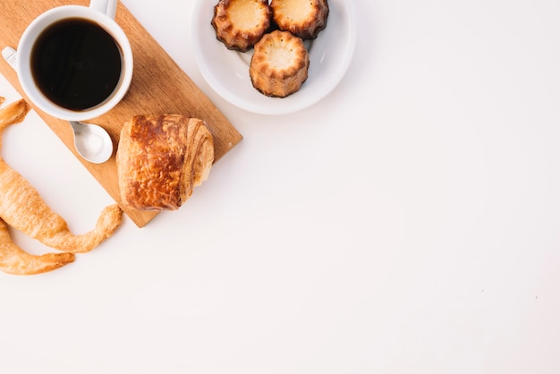 Free photo coffee cup with different bakery on white table