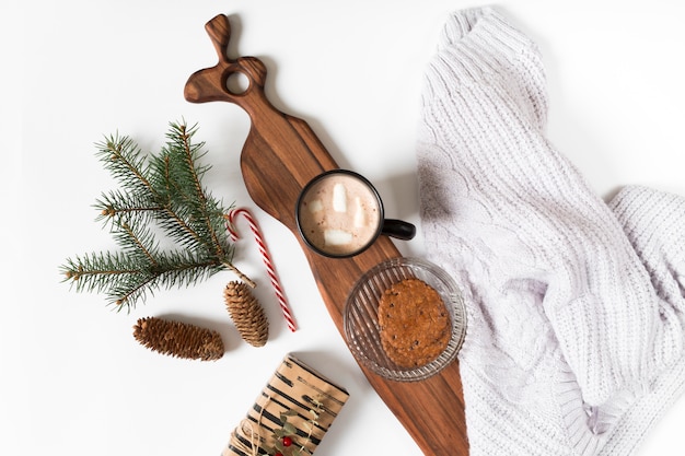 Coffee cup with fir tree branch on table