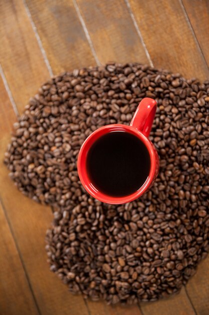 Coffee cup with heart shaped coffee beans