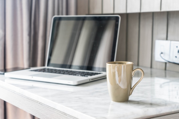 Free Photo coffee cup with laptop and beautiful luxury table decoration in livingroom interior for background