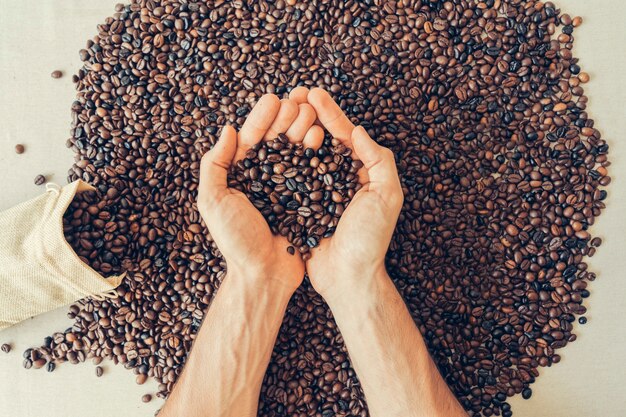 Coffee decoration with hands holding beans