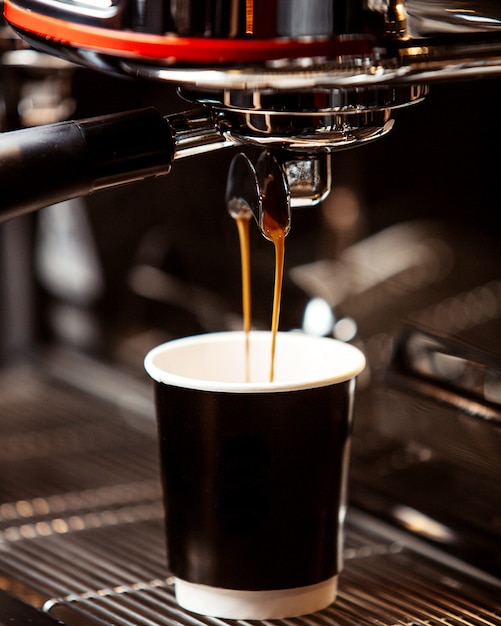  coffee is poured from the coffee machine