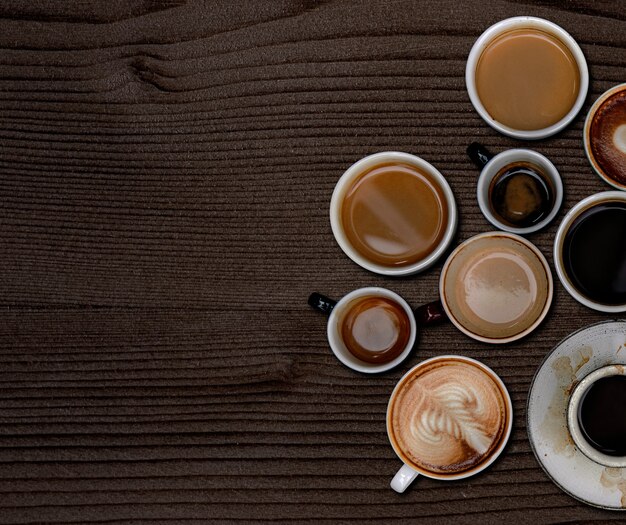 Coffee mugs on a dark brown wooden textured wallpaper