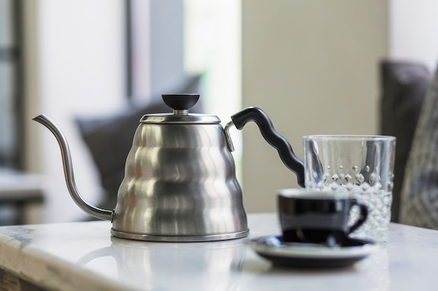 Free photo coffee pot standing on table